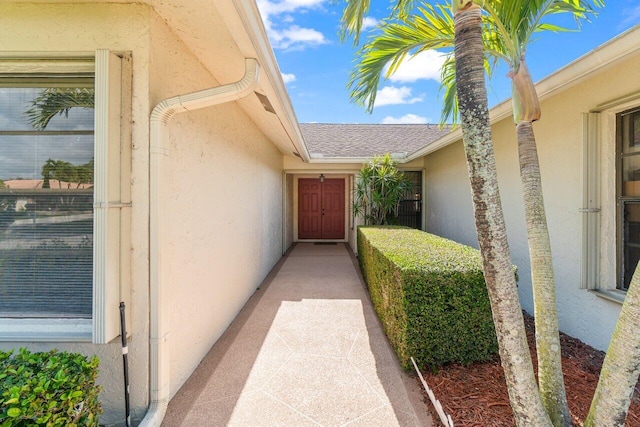 view of exterior entry with stucco siding