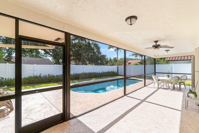 view of swimming pool with a patio area, a fenced backyard, and ceiling fan
