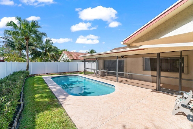 view of swimming pool with a fenced backyard, a patio, a sunroom, and a ceiling fan