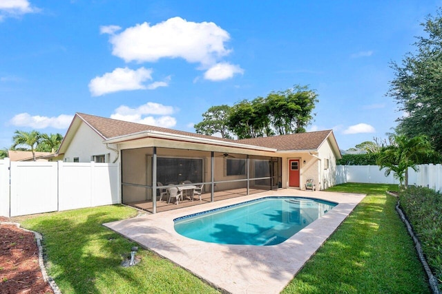 rear view of house with a ceiling fan, stucco siding, a patio area, and a sunroom