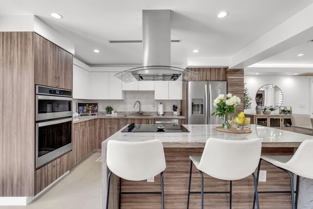 11290 SW 48th St, Miami, FL 33165 - kitchen with stainless steel appliances, modern cabinets, a sink, a breakfast bar, and recessed lighting