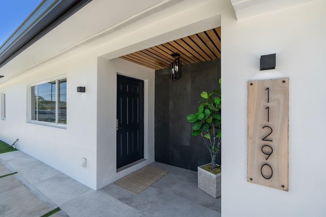 11290 SW 48th St, Miami, FL 33165 - doorway to property featuring stucco siding
