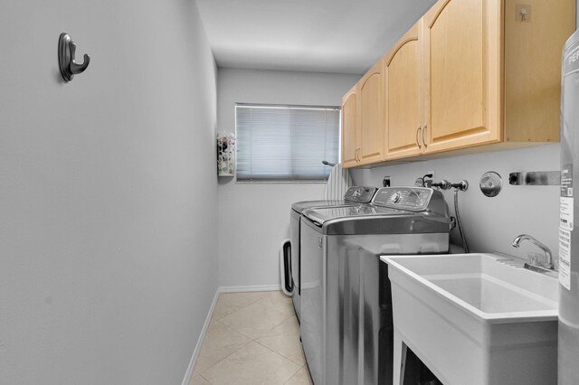 6851 Giralda Cir, Boca Raton, FL 33433 - laundry room featuring separate washer and dryer, cabinet space, baseboards, and light tile patterned floors