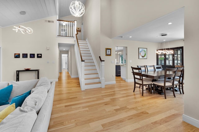 6851 Giralda Cir, Boca Raton, FL 33433 - dining space featuring a chandelier, stairway, baseboards, light wood-type flooring, and recessed lighting