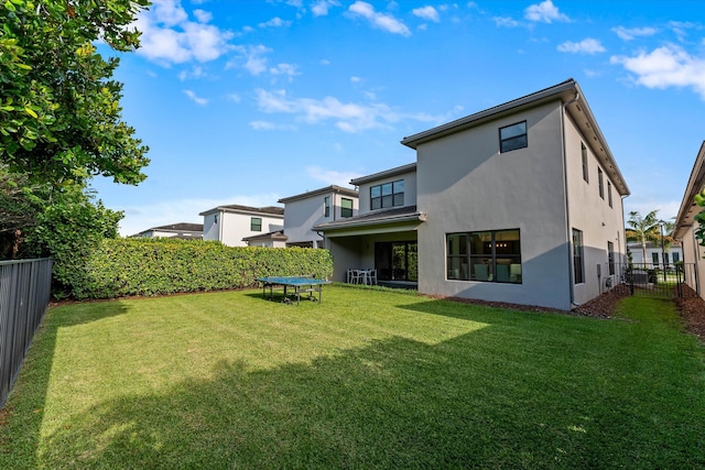 17516 Rainstream Rd, Boca Raton, FL 33496 - back of property featuring a trampoline and stucco siding