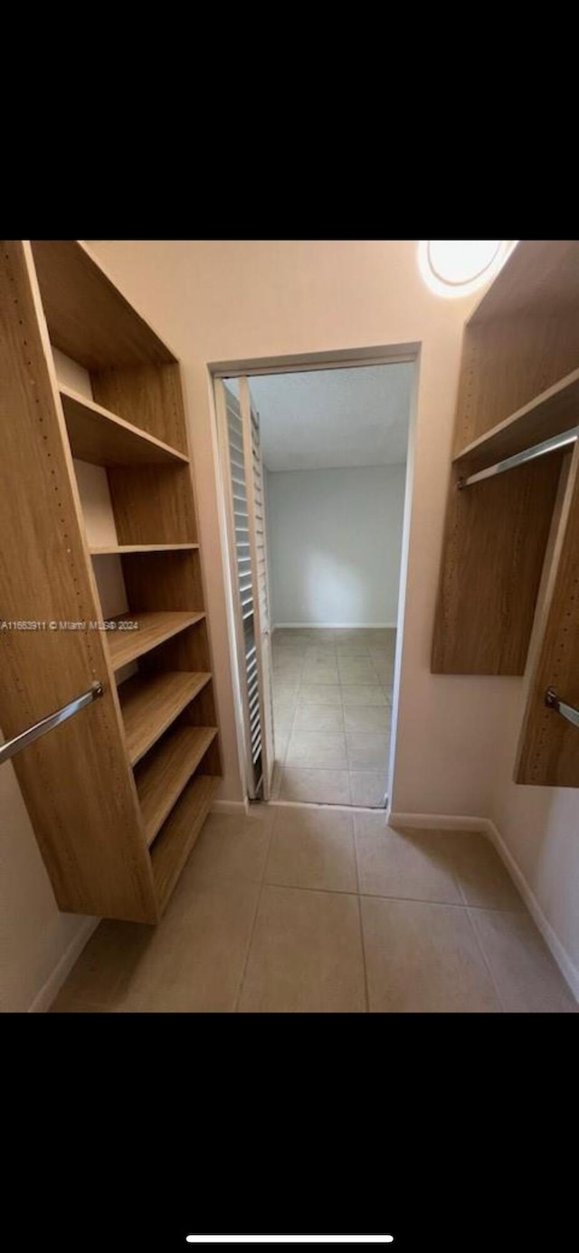 307 Pine Ridge Cir Unit C1, Greenacres, FL 33463 - walk in closet with light tile patterned floors