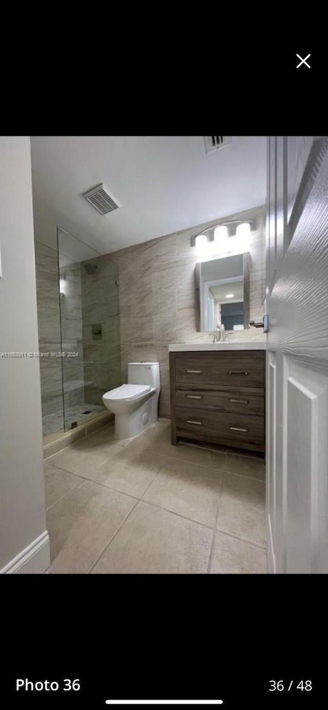 307 Pine Ridge Cir Unit C1, Greenacres, FL 33463 - bathroom featuring tile patterned floors, toilet, vanity, and walk in shower