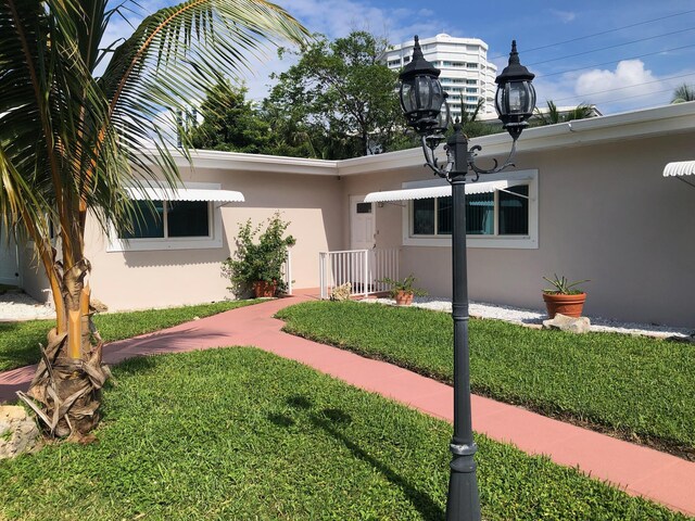 1760 Bel Air Ave, Lauderdale By The Sea, FL 33062 - view of front of property featuring stucco siding and a front yard