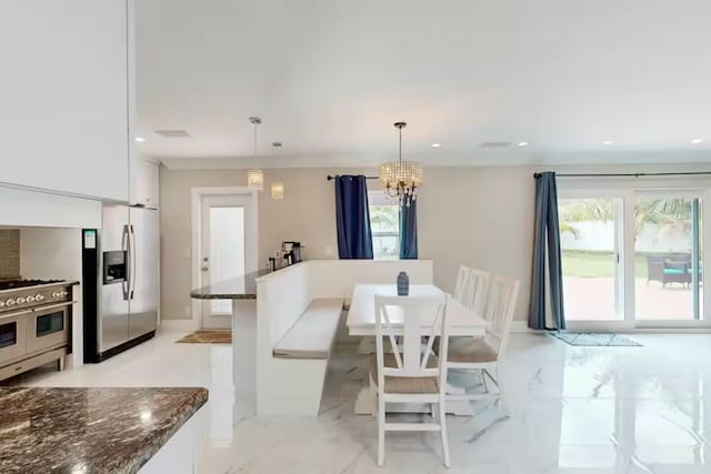 1760 Bel Air Ave, Lauderdale By The Sea, FL 33062 - dining space featuring healthy amount of natural light, a chandelier, recessed lighting, and light marble finish flooring