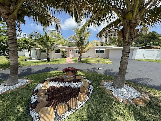 1760 Bel Air Ave, Lauderdale By The Sea, FL 33062 - view of front of home with curved driveway, stucco siding, and a gate