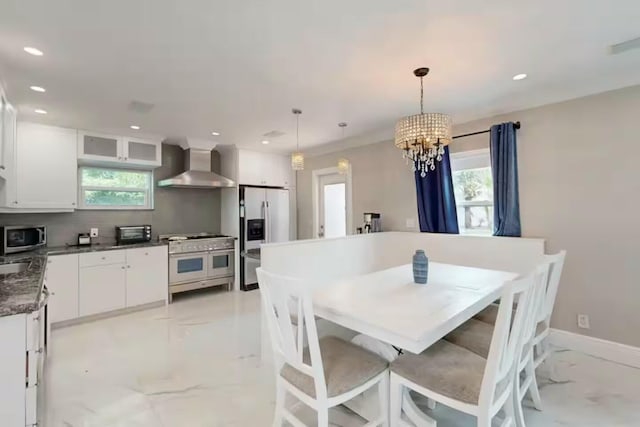 1760 Bel Air Ave, Lauderdale By The Sea, FL 33062 - dining room featuring light marble finish flooring, recessed lighting, healthy amount of natural light, and a chandelier