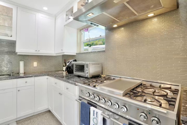 1760 Bel Air Ave, Lauderdale By The Sea, FL 33062 - kitchen with high end stove, wall chimney exhaust hood, backsplash, white cabinets, and glass insert cabinets