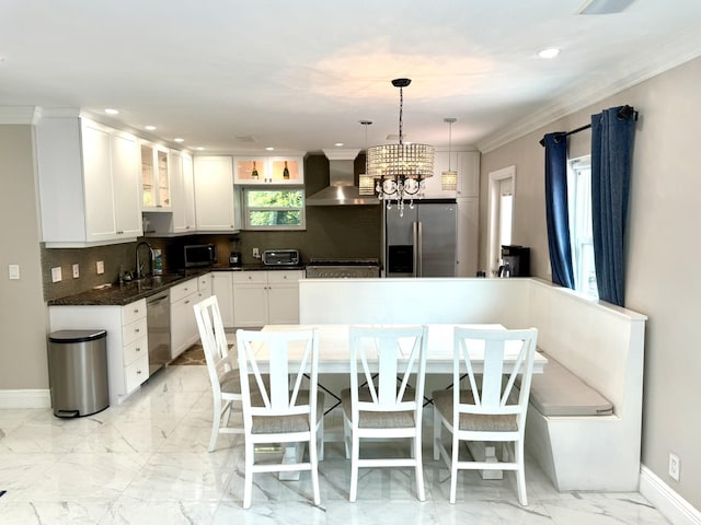 1760 Bel Air Ave, Lauderdale By The Sea, FL 33062 - kitchen featuring appliances with stainless steel finishes, wall chimney range hood, a chandelier, backsplash, and dark countertops