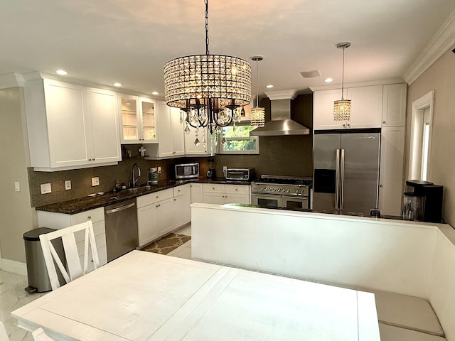 1760 Bel Air Ave, Lauderdale By The Sea, FL 33062 - kitchen with appliances with stainless steel finishes, wall chimney range hood, marble look tile flooring, white cabinetry, and recessed lighting