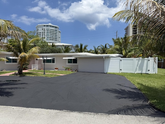 1760 Bel Air Ave, Lauderdale By The Sea, FL 33062 - art deco house with asphalt driveway, stucco siding, and a gate