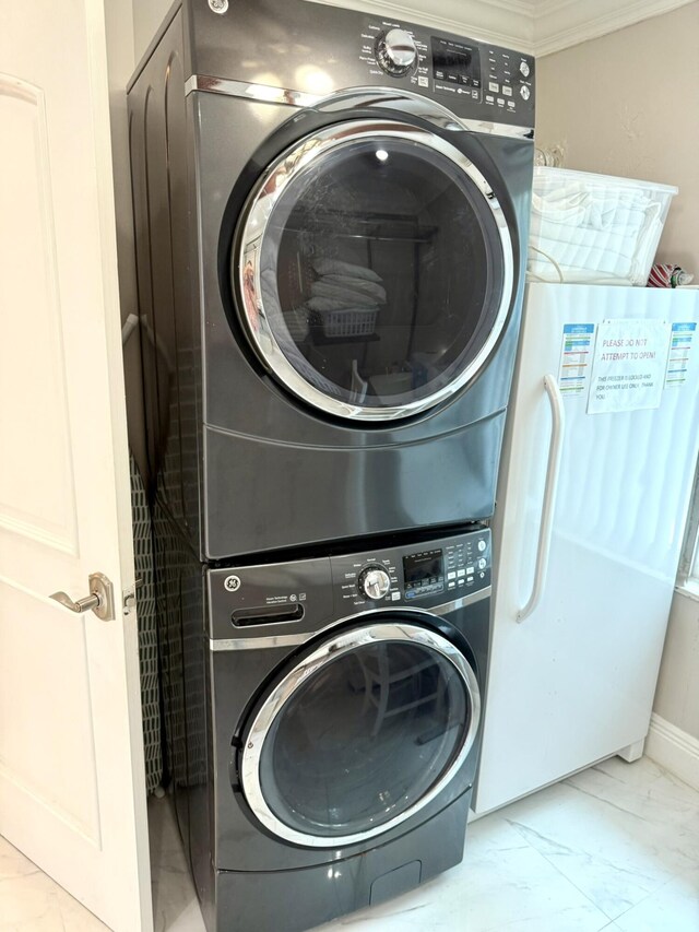 1760 Bel Air Ave, Lauderdale By The Sea, FL 33062 - washroom with stacked washer / dryer, marble finish floors, and ornamental molding