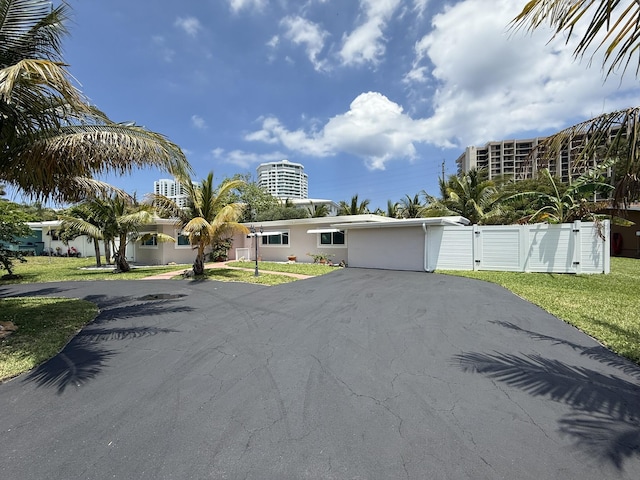 1760 Bel Air Ave, Lauderdale By The Sea, FL 33062 - view of front facade with asphalt driveway and stucco siding