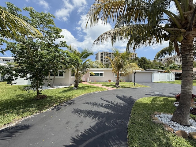 1760 Bel Air Ave, Lauderdale By The Sea, FL 33062 - view of front of property featuring stucco siding, a front lawn, and driveway
