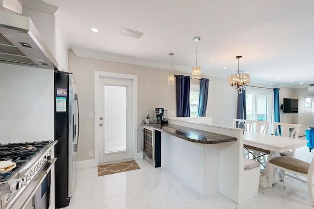 1760 Bel Air Ave, Lauderdale By The Sea, FL 33062 - kitchen with appliances with stainless steel finishes, a peninsula, wall chimney exhaust hood, a chandelier, and wine cooler