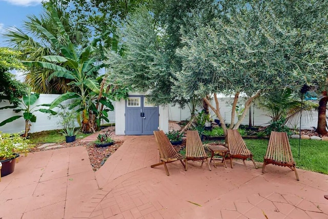 1760 Bel Air Ave, Lauderdale By The Sea, FL 33062 - fenced backyard with a patio area and a storage unit