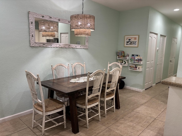275 SW 7th Ct, Pompano Beach, FL 33060 - tiled dining room featuring baseboards and a chandelier