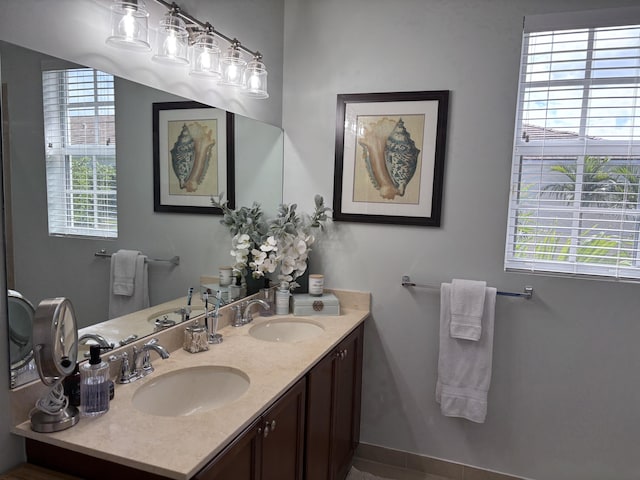 275 SW 7th Ct, Pompano Beach, FL 33060 - bathroom featuring plenty of natural light, baseboards, and double vanity