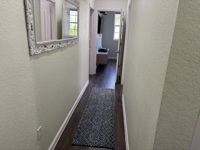 275 SW 7th Ct, Pompano Beach, FL 33060 - corridor featuring a textured wall, wood finished floors, and baseboards