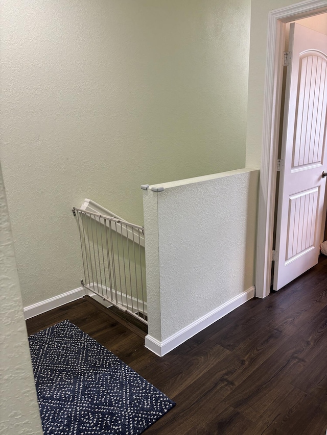 275 SW 7th Ct, Pompano Beach, FL 33060 - stairs featuring wood finished floors, a textured wall, and baseboards