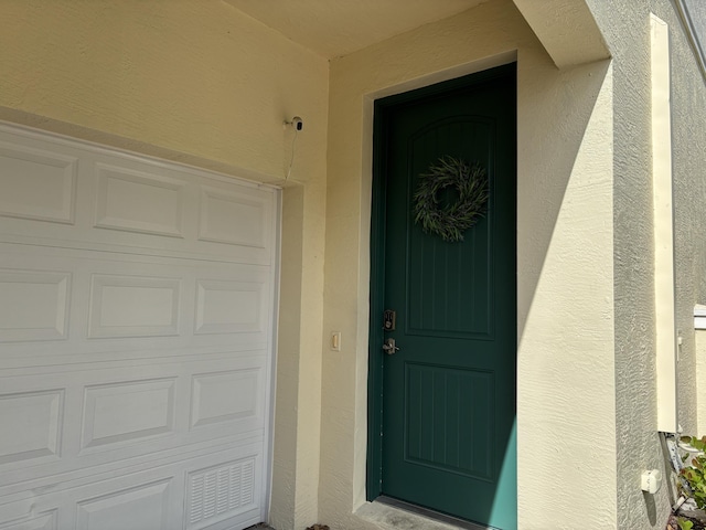 275 SW 7th Ct, Pompano Beach, FL 33060 - entrance to property featuring stucco siding and a garage