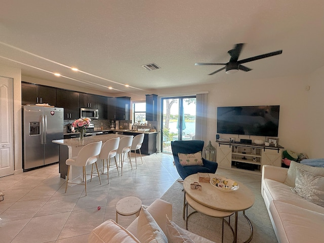 13007 Anthorne Ln, Boynton Beach, FL 33436 - living room featuring a ceiling fan, light tile patterned floors, recessed lighting, and a textured ceiling