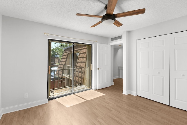 1402 Nebraska Ave Unit 3B, Fort Pierce, FL 34950 - unfurnished bedroom with access to outside, wood finished floors, a textured ceiling, baseboards, and ceiling fan