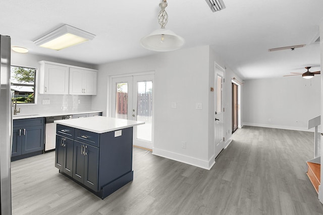 1402 Nebraska Ave Unit 3B, Fort Pierce, FL 34950 - kitchen featuring dishwasher, white cabinets, light countertops, and light wood-style floors