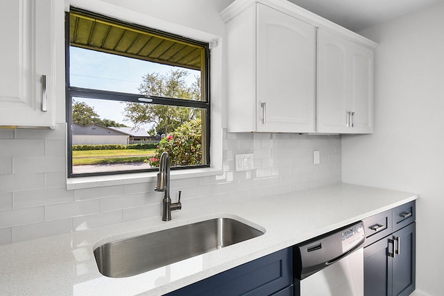 1402 Nebraska Ave Unit 3B, Fort Pierce, FL 34950 - kitchen featuring a sink, stainless steel dishwasher, tasteful backsplash, white cabinetry, and light stone countertops
