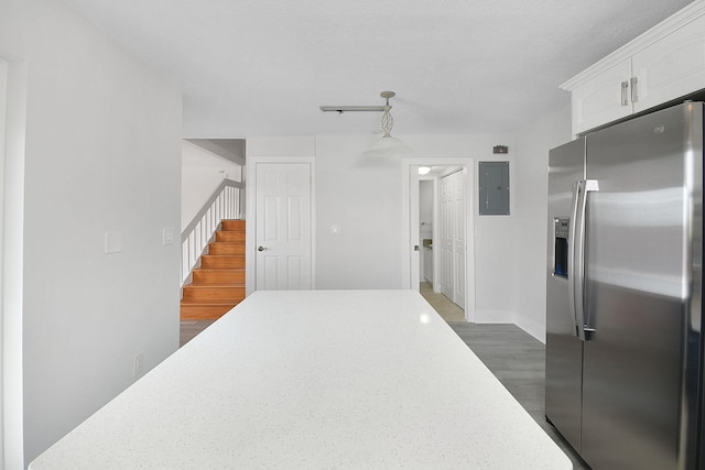 1402 Nebraska Ave Unit 3B, Fort Pierce, FL 34950 - kitchen with stainless steel fridge with ice dispenser, electric panel, white cabinets, light countertops, and dark wood finished floors