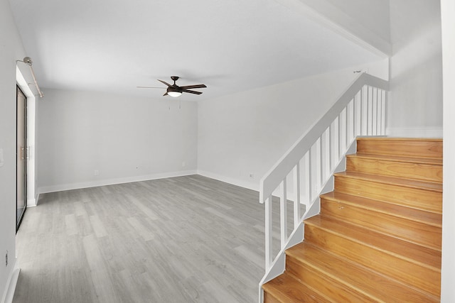 1402 Nebraska Ave Unit 3B, Fort Pierce, FL 34950 - staircase with a ceiling fan, wood finished floors, and baseboards