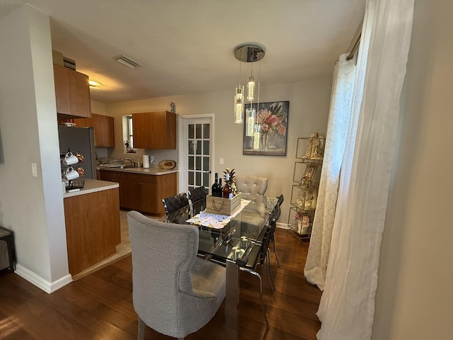 181 Morgans Way, Palm Springs, FL 33461 - dining room featuring dark wood-type flooring, baseboards, and a chandelier