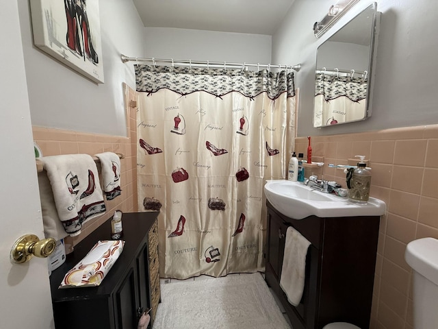 181 Morgans Way, Palm Springs, FL 33461 - bathroom with tile walls, vanity, a wainscoted wall, a shower with shower curtain, and toilet