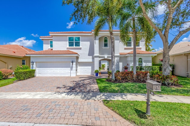 106 Sedona Way, Palm Beach Gardens, FL 33418 - mediterranean / spanish home featuring decorative driveway, stucco siding, a tile roof, and a garage