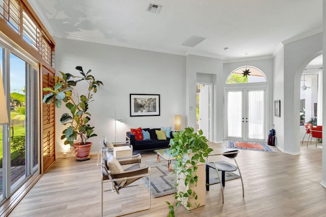 106 Sedona Way, Palm Beach Gardens, FL 33418 - living room with french doors, arched walkways, light wood-style floors, ornamental molding, and baseboards