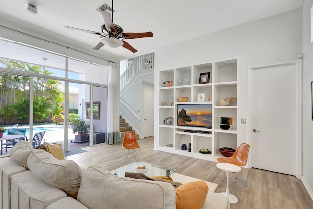 106 Sedona Way, Palm Beach Gardens, FL 33418 - living area featuring a ceiling fan, light wood finished floors, and stairs