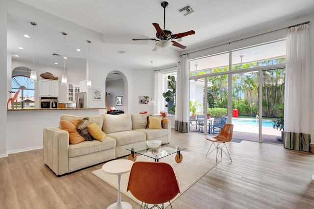 106 Sedona Way, Palm Beach Gardens, FL 33418 - living area featuring arched walkways, ceiling fan, light wood-type flooring, plenty of natural light, and recessed lighting
