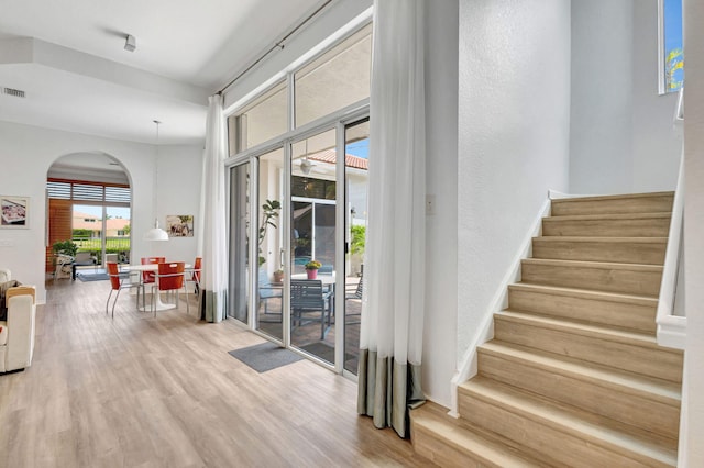 106 Sedona Way, Palm Beach Gardens, FL 33418 - stairway featuring arched walkways and wood finished floors