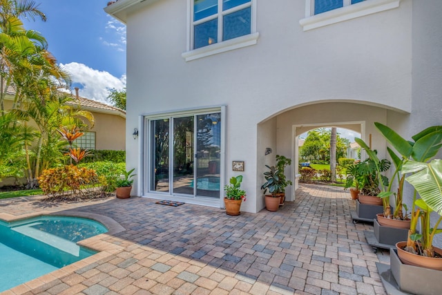106 Sedona Way, Palm Beach Gardens, FL 33418 - rear view of property with stucco siding, a patio, and an outdoor pool