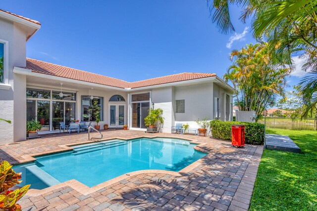 106 Sedona Way, Palm Beach Gardens, FL 33418 - view of swimming pool with french doors, a patio, fence, a pool with connected hot tub, and ceiling fan