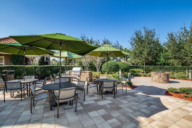 10557 Pisa Rd, Wellington, FL 33414 - view of patio / terrace with outdoor dining area, an outdoor kitchen, and fence