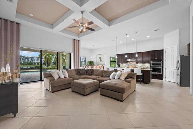 10557 Pisa Rd, Wellington, FL 33414 - living area featuring a high ceiling, coffered ceiling, light tile patterned floors, a ceiling fan, and beam ceiling