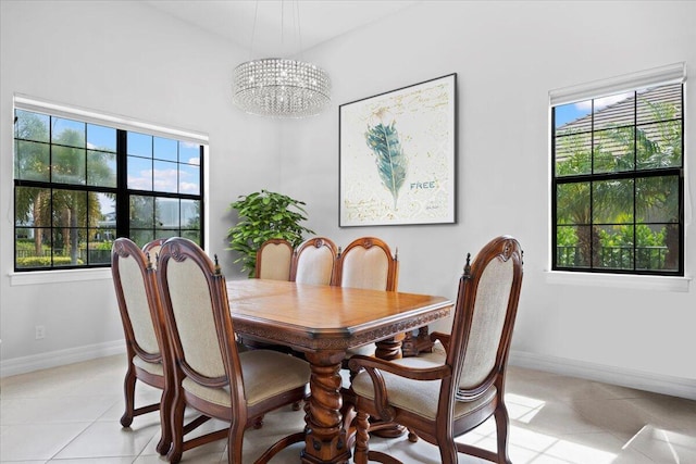 10557 Pisa Rd, Wellington, FL 33414 - dining area featuring light tile patterned flooring, a chandelier, and baseboards