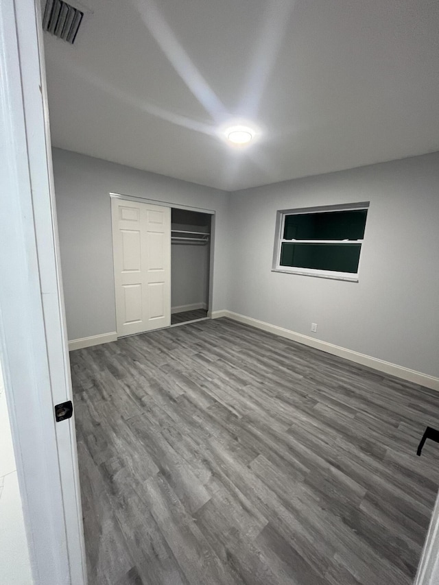 1720 SW 13th St, Boca Raton, FL 33486 - unfurnished bedroom featuring wood finished floors, baseboards, and a closet