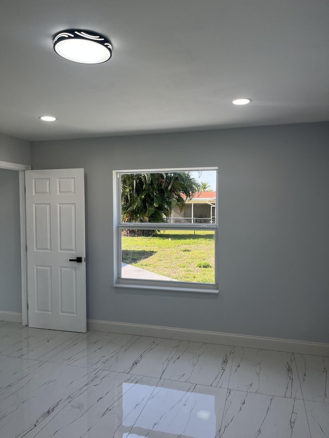 1720 SW 13th St, Boca Raton, FL 33486 - spare room featuring baseboards, marble look tile flooring, recessed lighting, and plenty of natural light
