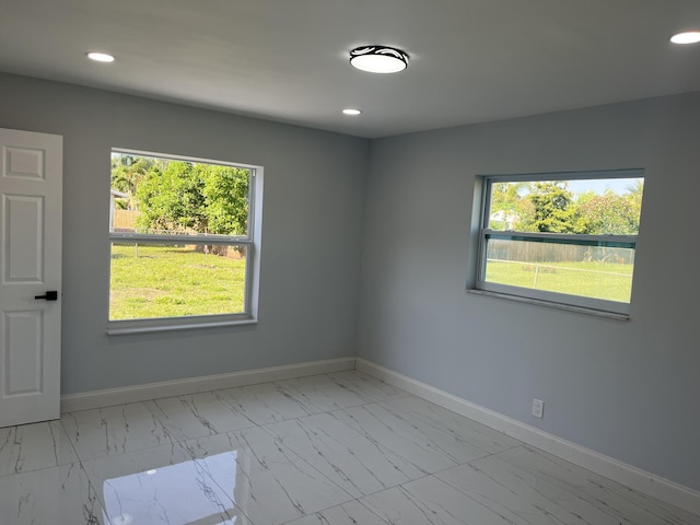 1720 SW 13th St, Boca Raton, FL 33486 - unfurnished room with light marble finish floors, baseboards, healthy amount of natural light, and recessed lighting